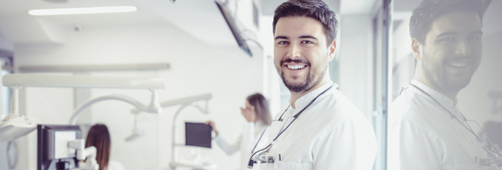 Male doctor looking at camera in hospital room