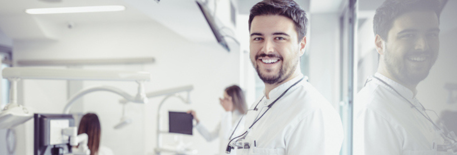 Male doctor looking at camera in hospital room