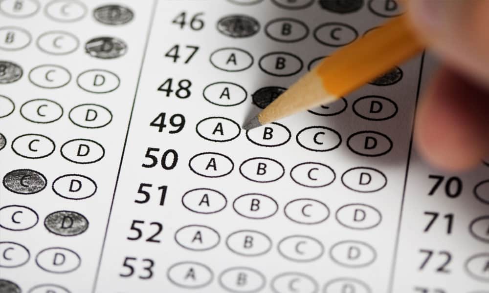 scantron test being filled in with a pencil by a human hand