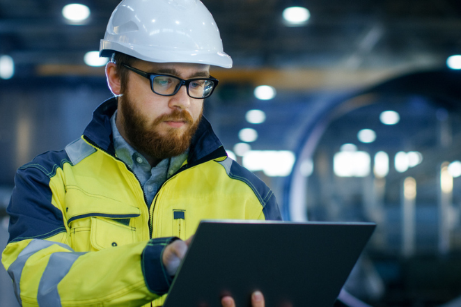 auditor wearing hard hat completing an audit