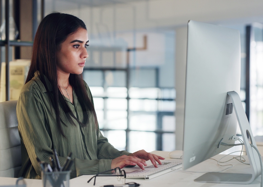 woman using desktop computer in office