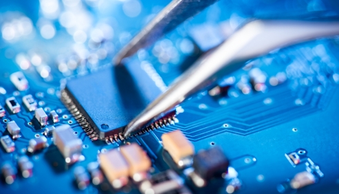 tweezer needles adjusting components on a circuit board