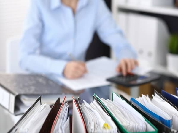 man at desk reviewing paperwork