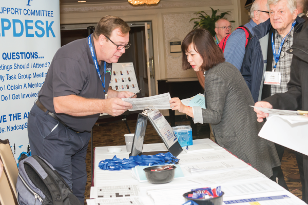 SSC employee assisting attendee at meeting