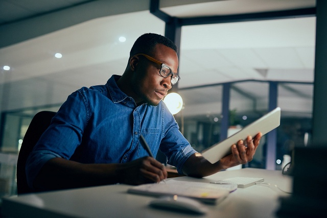 man studying at a desk with papers