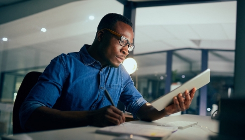 man studying at a desk with papers