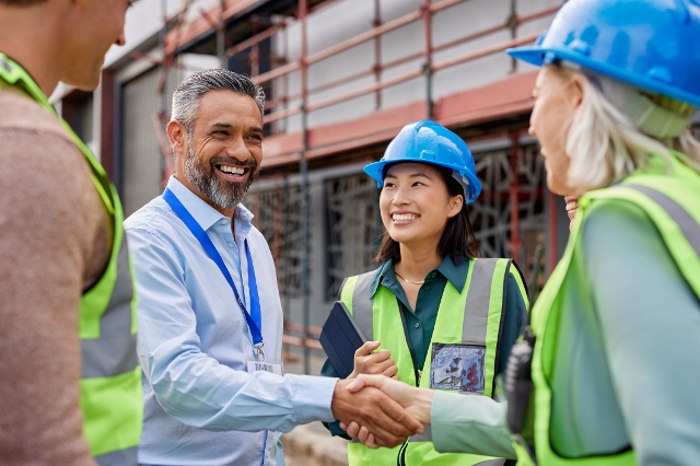auditor shaking hands with group