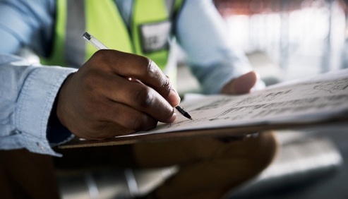 man writing something on a piece of paper