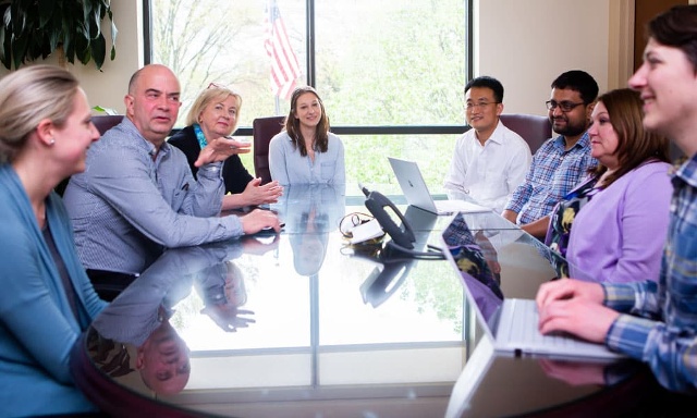 Medical equipment provider industry leaders discussing Accreditation at a conference room table.