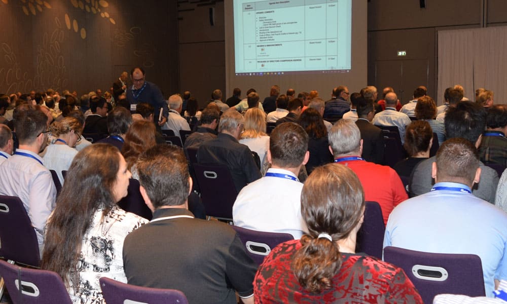 people listening to a presentation at conference
