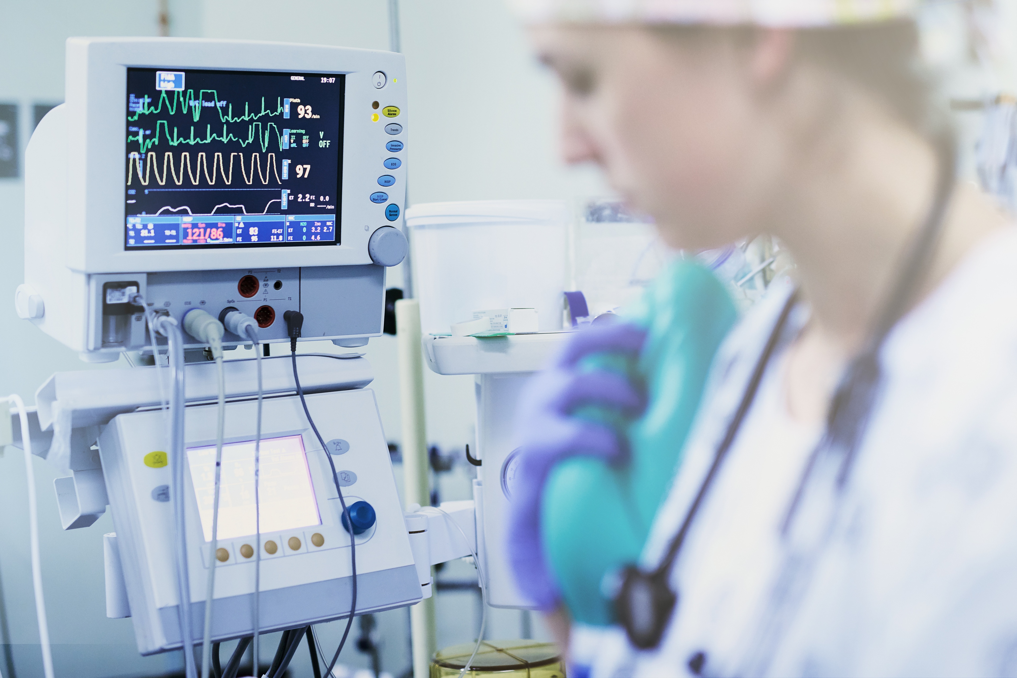medical professional standing in front of a medical device