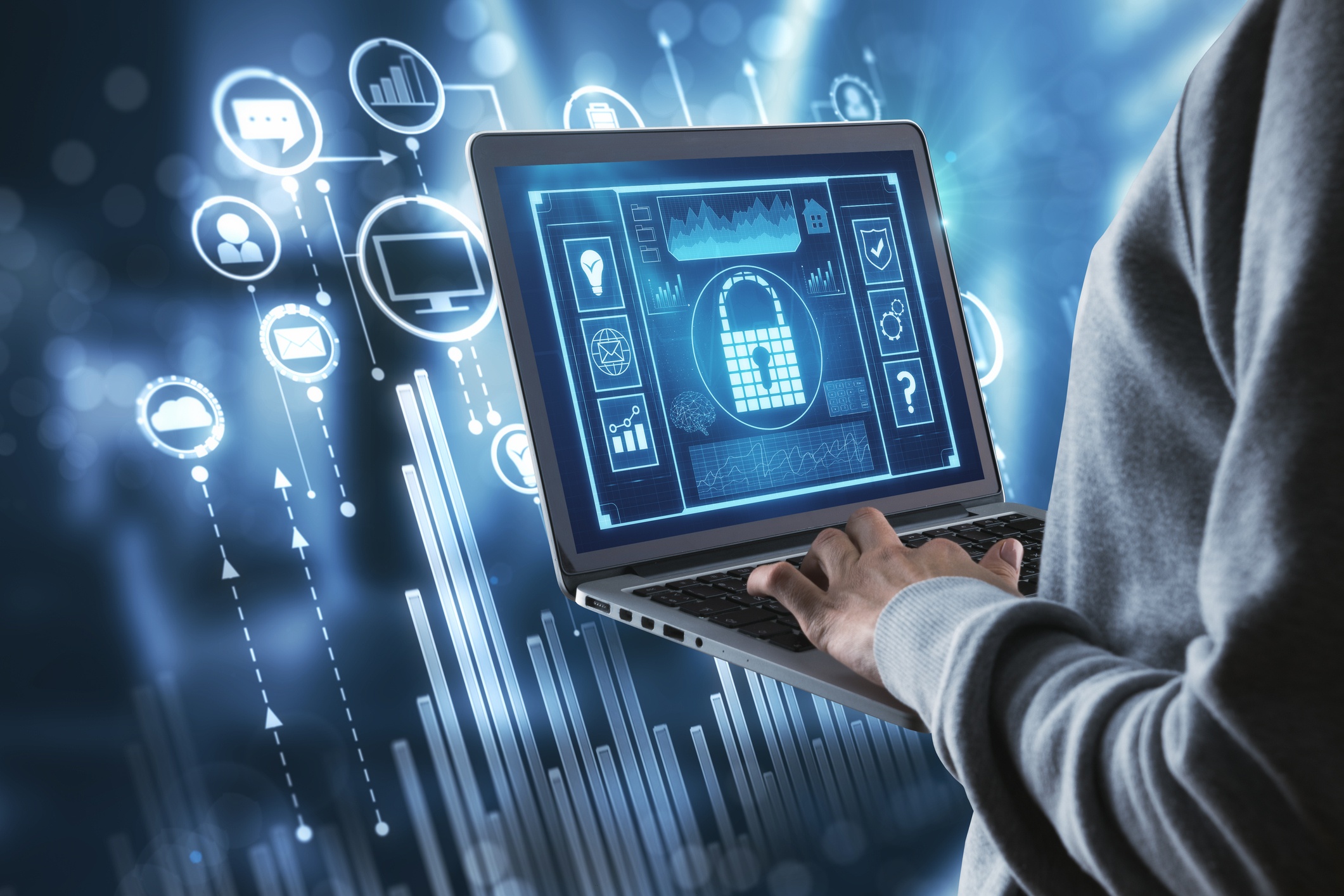 man standing holding a laptop with a digital lock on signifying information security