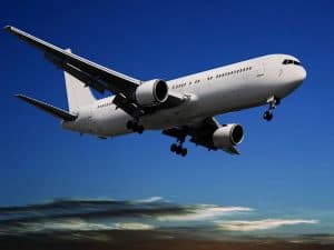airplane landing on a runaway on a sunny day