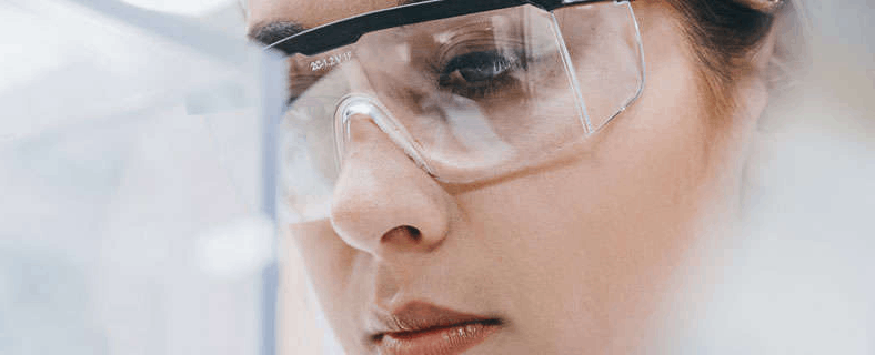 female medical professional with safety glasses on