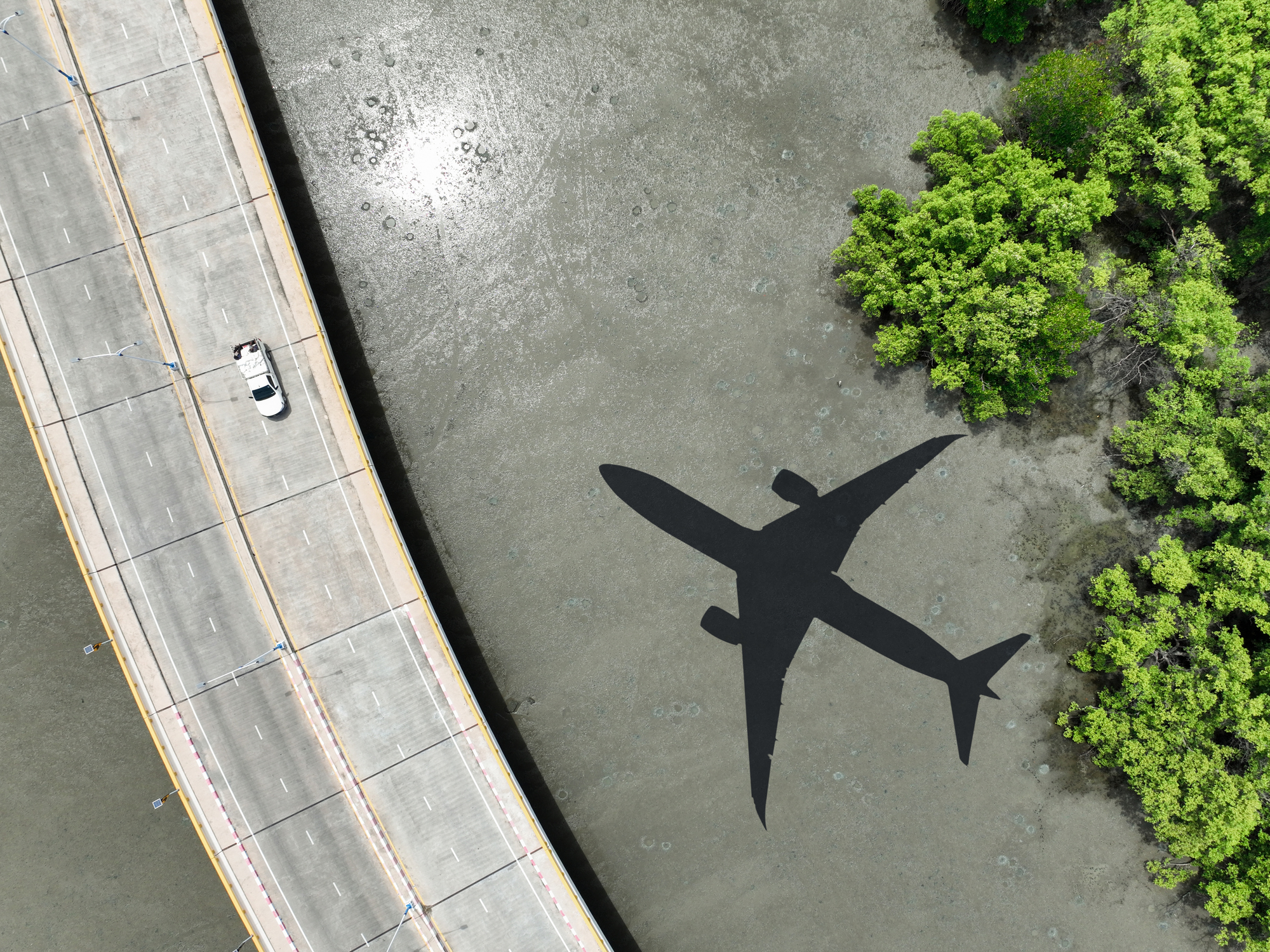 Shadow of airplane over highway
