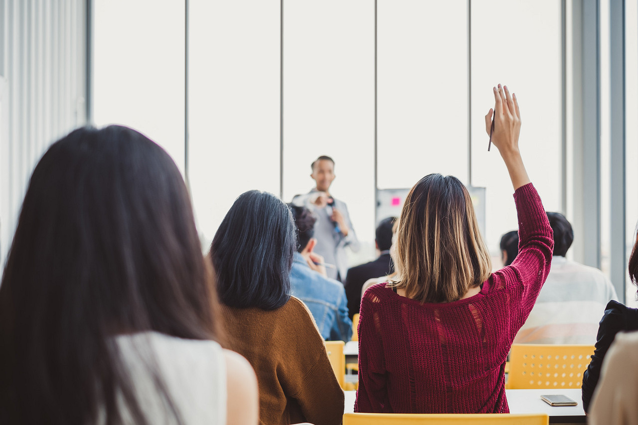 small class of aerospace professionals taking a PRI Training course in Quality raising their hands and engaging with the instructor